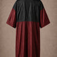 Burgundy iridescent snap-front salon robe back view with black waterproof upper-back panel