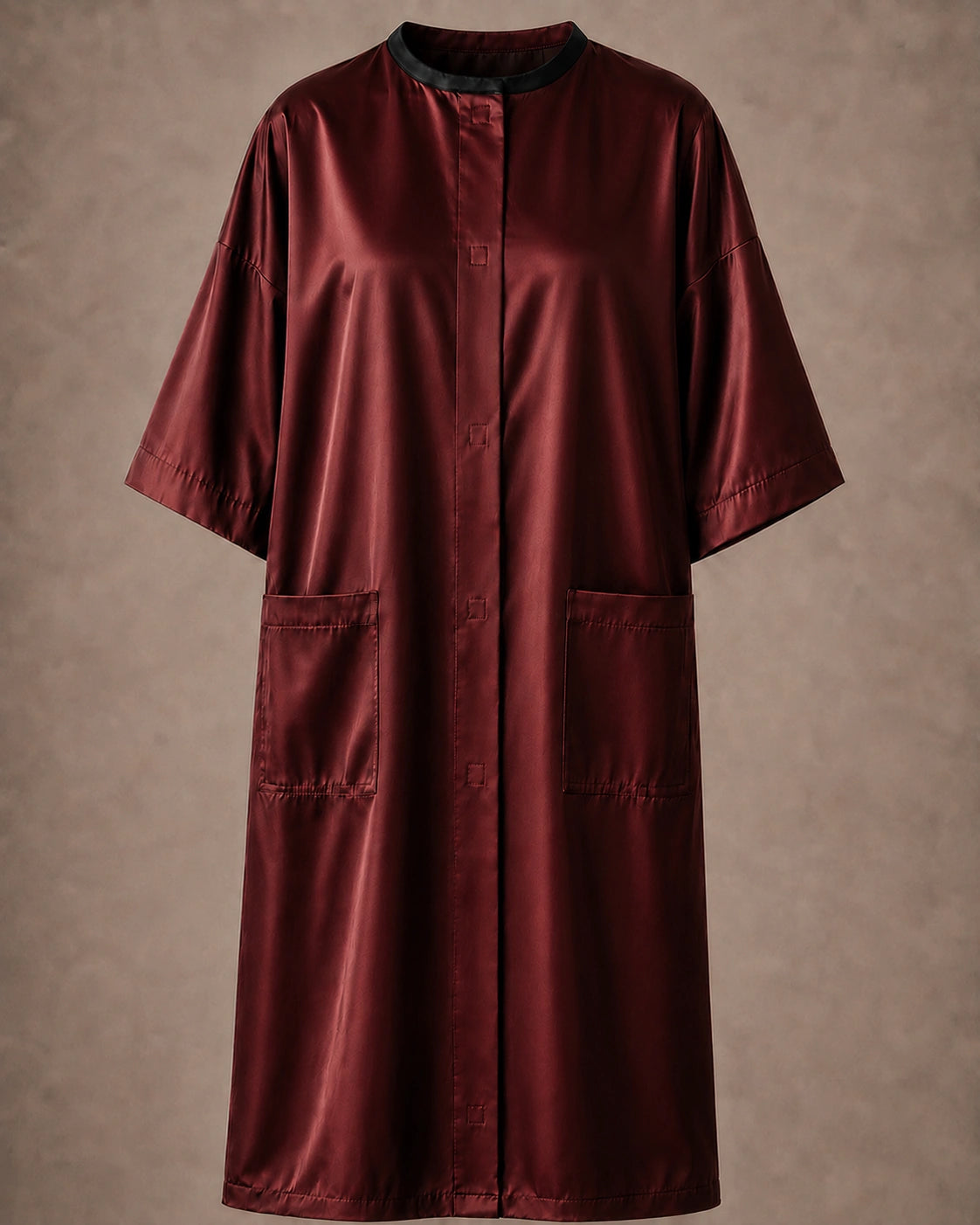 Burgundy iridescent snap-front salon robe front view with black collar trim, short sleeves and front pockets