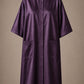 Eggplant iridescent snap-front salon robe front view with black collar trim, short sleeves and front pockets