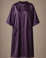 Eggplant iridescent snap-front salon robe front view with black collar trim, short sleeves and front pockets