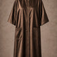 Brown iridescent snap-front salon robe front view with black collar trim, short sleeves and front pockets