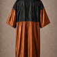 Copper iridescent snap-front salon robe back view with black waterproof upper-back panel