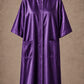 Purple iridescent snap-front salon robe front view with black collar trim, short sleeves and front pockets
