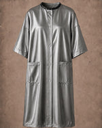 Silver iridescent snap-front salon robe front view with black collar trim, short sleeves and front pockets