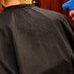 Water beading on black waterproof SalonCapes chemical cape fabric