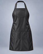 Black SalonCapes waterproof chemical apron with chest pocket and three lower storage pockets, front view