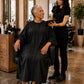 Black Crepe Snap-Front Client Robe worn during seated salon consultation