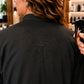 Close-up of water beading on waterproof back panel of Black Crepe Snap-Front Client Robe