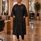 Black SalonCapes snap-front robe embroidered with Vogue Salon logo in a professional salon