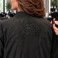 Close-up of water beading on black waterproof back panel of zipper-front salon robe