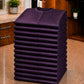 Stack of 13 folded eggplant iridescent snap-front salon robes for Baker’s Dozen bulk ordering