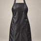 Black SalonCapes iridescent apron with chest pocket and three lower storage pockets, front view