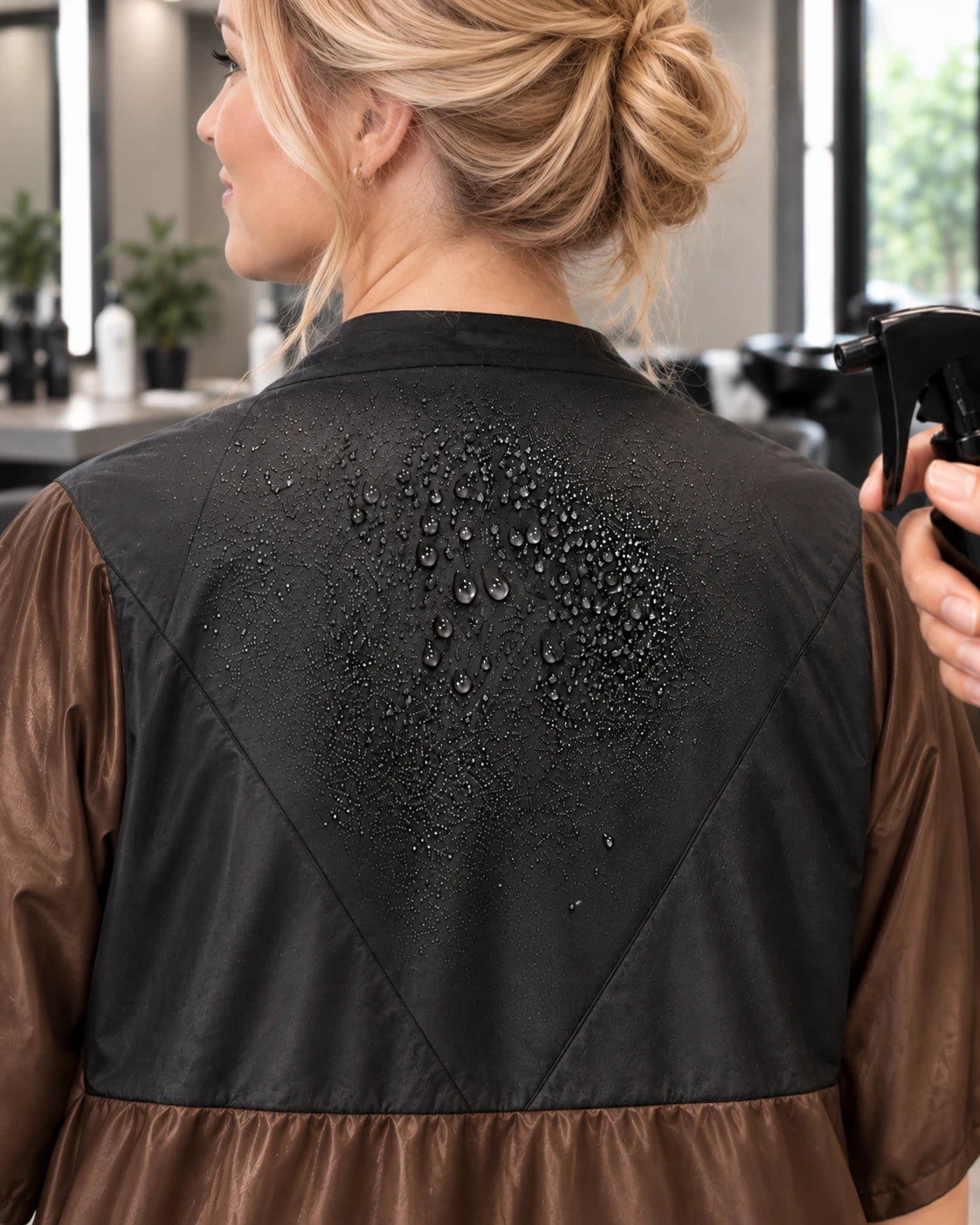Close-up of water beading on black waterproof panel of iridescent brown zipper-front robe