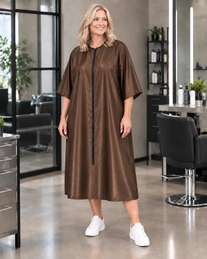 Iridescent brown zipper-front salon robe on woman standing in modern salon