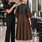 Iridescent brown zipper-front salon robe with black waterproof upper-back panel and water droplets