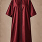 Iridescent burgundy zipper-front salon robe front view with black center zipper