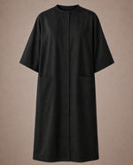 Black iridescent snap-front salon robe front view with black collar trim, short sleeves and front pockets