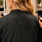 Close-up of water beading on black waterproof back panel of Burgundy Iridescent Kimono Client Robe