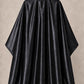 Black iridescent SalonCapes cutting cape front view
