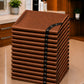 Stack of 13 copper iridescent SalonCapes cutting capes representing the Baker’s Dozen bulk purchase option