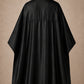 Black SalonCapes reversible chemical cape back view showing black collar and reversible seam construction