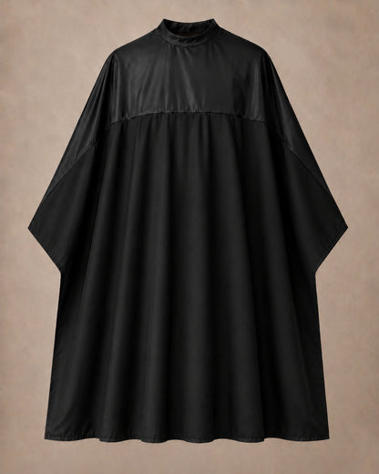 Black-on-black SalonCapes reversible chemical cape front view