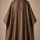 Brown SalonCapes reversible chemical cape back view showing black collar and reversible seam construction