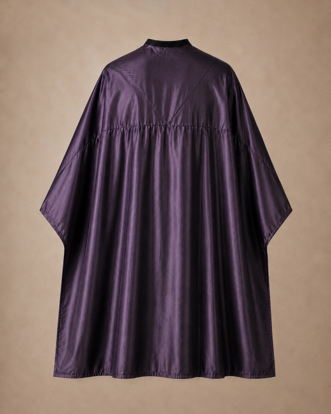 Eggplant SalonCapes reversible chemical cape back view showing black collar and reversible seam construction