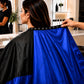 Adjustable snap neckline on SalonCapes reversible chemical cape showing secure client fit