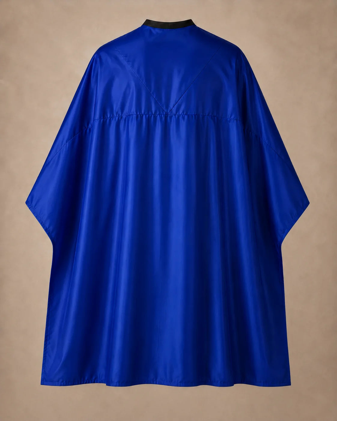 Royal blue SalonCapes reversible chemical cape back view showing black collar and reversible seam construction