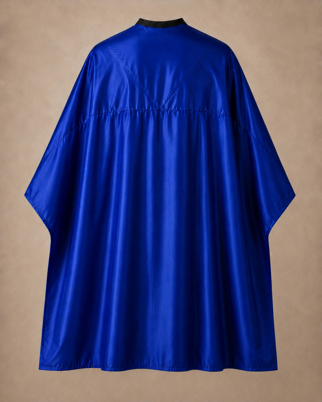 Royal blue SalonCapes reversible chemical cape back view showing black collar and reversible seam construction