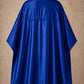 Royal blue SalonCapes reversible chemical cape back view showing black collar and reversible seam construction